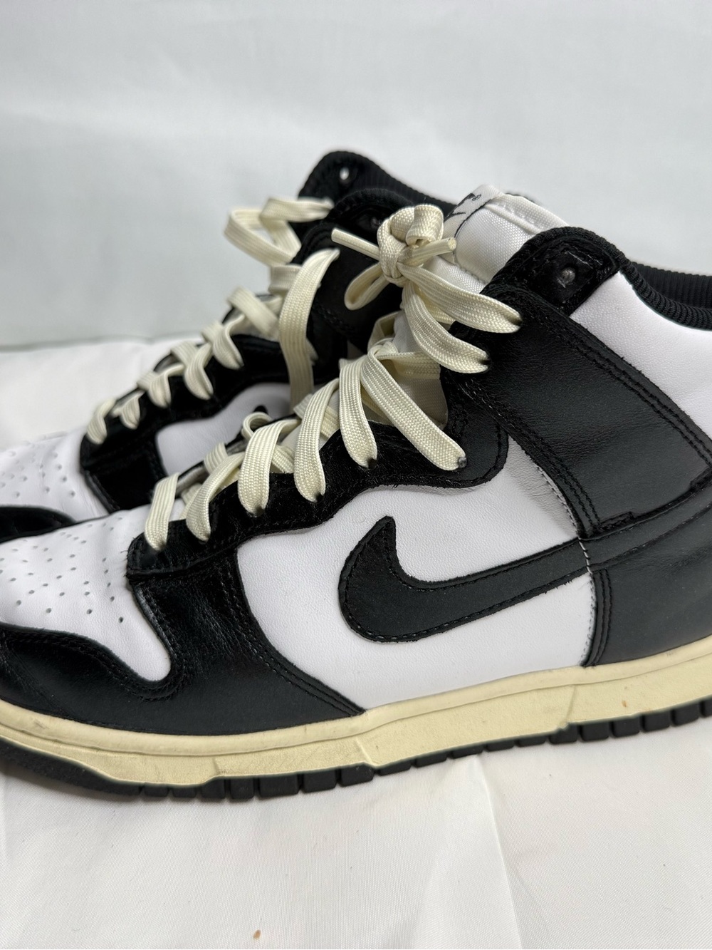 pair of Nike Women's Dunk High "Vintage Black" sneakers featuring a classic blac